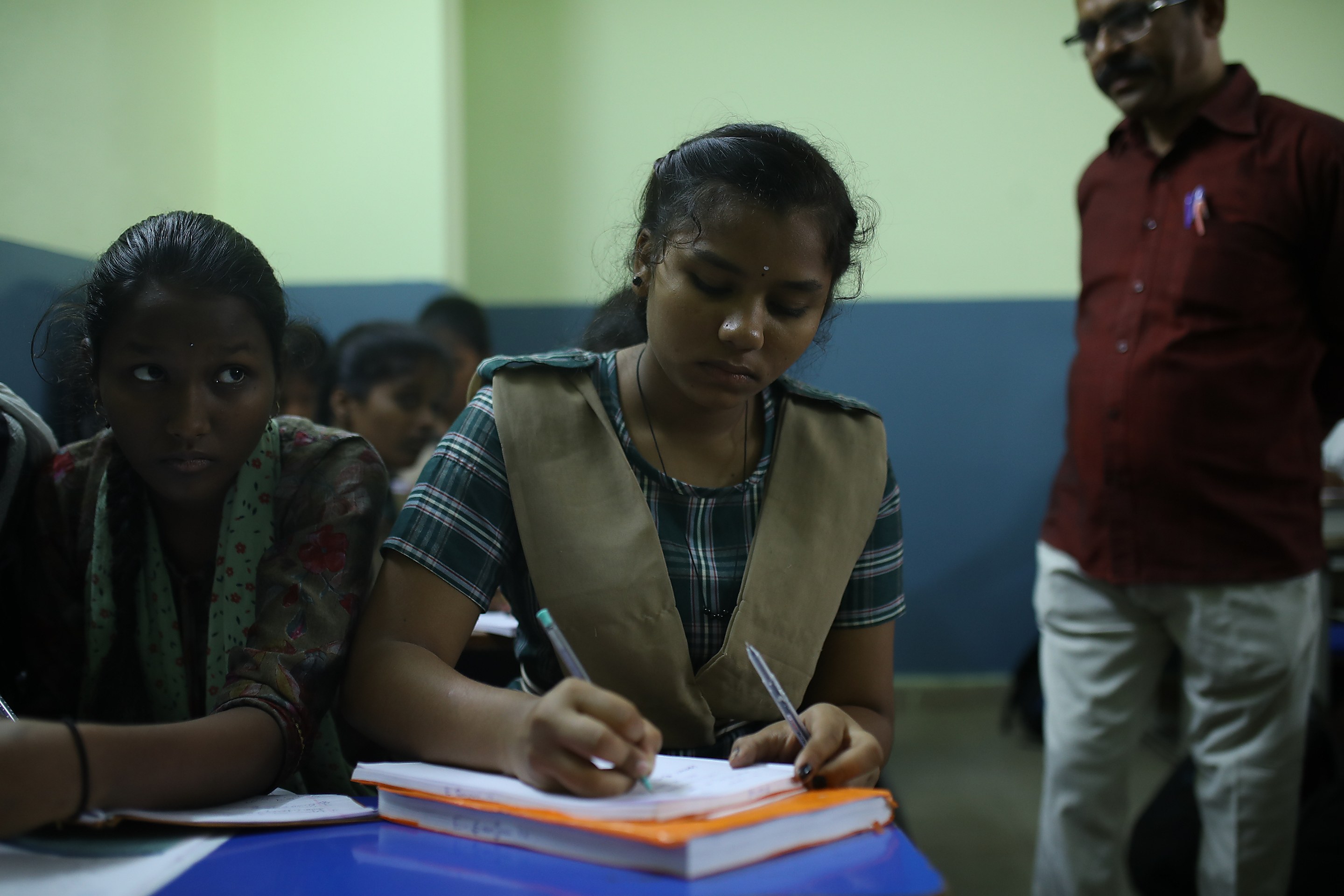 Young women writing in their notebooks at a Foundation study session